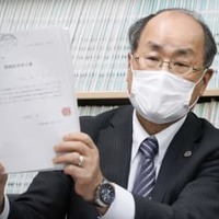 名張毒ぶどう酒事件で、特別抗告の申立書を手に記者会見する鈴木泉弁護団長＝9日午後、名古屋市