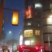 炎が上がる焼き肉店「大東園本店」の火災現場＝9日夜、福岡市博多区上川端町（住民提供）