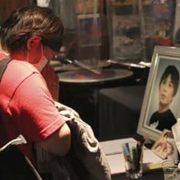 ライブハウス「新宿ロフト」に飾られた南野信吾さんの遺影の前で手を合わせる来場者＝10日午後、東京都新宿区