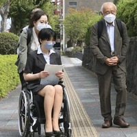 訴状提出のため大分地裁に入る原告の福山陽子さん（左手前）と徳田靖之弁護士（右）ら＝15日午後