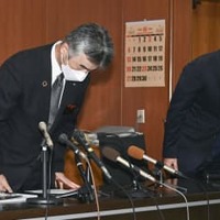 記者会見で謝罪する岩手県一関市教育委員会の小菅正晴教育長（左）＝8日午前、一関市役所