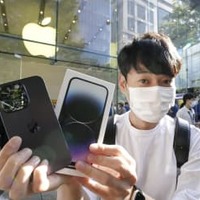 米アップル「iPhone」の新型「14」シリーズを購入した男性＝16日朝、東京・表参道