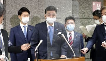 在日米軍駐留経費負担に関する日米合意について、取材に応じる岸防衛相（中央）＝21日午後、防衛省