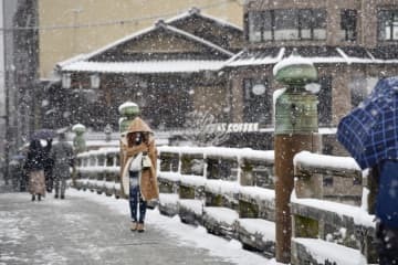 雪化粧した京都市の三条大橋＝14日午前8時24分