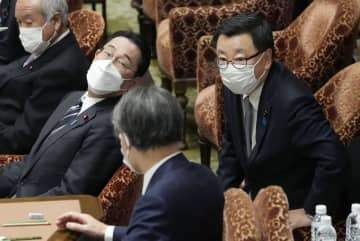 衆院予算委で、答弁のため席を立つ松野官房長官。手前左は岸田首相＝18日午後