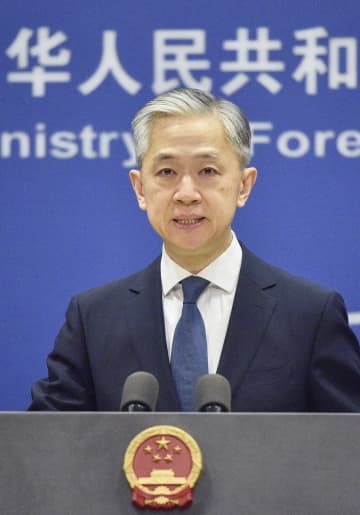 記者会見する中国外務省の汪文斌副報道局長＝21日、北京（共同）