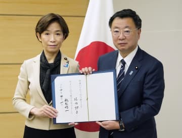ワクチン接種推進担当相を辞任した堀内詔子氏（左）との事務引き継ぎ式に臨む松野官房長官＝1日午前、首相官邸