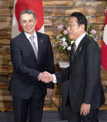 スイスのカシス大統領兼外相（左）との会談を前に握手する岸田首相＝18日午後、首相官邸