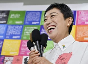 比例代表で当選が決まり、記者の質問に笑顔で答える立憲民主党の辻元清美氏＝10日夜、大阪府高槻市