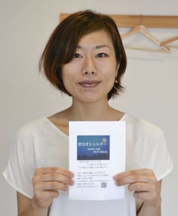 「夜泣きシェルター」のチラシを手にする親子向けカフェ経営の上野いずみさん