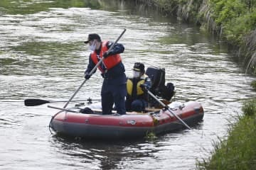 行方不明になった高嶋怜音ちゃんの自宅付近の川をボートで捜索する警察官＝22日午後、富山県高岡市