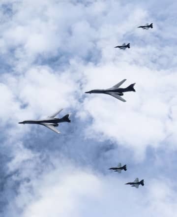 共同訓練をする米軍のB1B戦略爆撃機（中央の2機）と航空自衛隊のF2戦闘機＝19日、九州北西（防衛省統合幕僚監部提供）